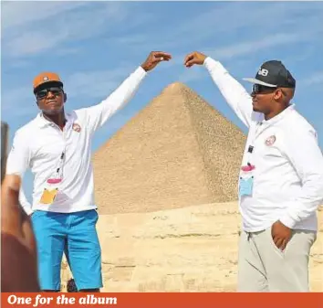  ?? Reuters ?? Members of Fifa, on a trip to Egypt, take photos at the Giza pyramids on the outskirts of Cairo on Wednesday. The pyramids are one of the Seven Wonders of the ancient world.