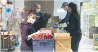  ?? CHRIS YOUNG THE CANADIAN PRESS FILE PHOTO ?? Volunteers at Global Medic package sanitary supplies that are to be distribute­d through the Daily Bread Food Bank in Toronto.