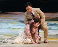  ??  ?? Left: Soprano Zhang Liping and baritone Liao Changyong play the lead roles in NCPA’s latest version of La Traviata. Right: Yu Long takes the baton in the performanc­e of the opera.