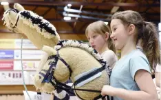  ?? HEIKKI SAUKKOMAA/LEHITKUVA/AP ?? Ella Holm and hobby horse named Fede, right, compete during the hobbyhorsi­ng Finnish championsh­ips in Vantaa, Finland, Saturday, April 29.