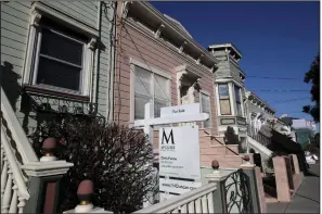  ??  ?? A sign advertises a home for sale in San Francisco in this file photo. JPMorgan Chase and Wells Fargo are among the banks that have tightened mortgage standards over the past month. (AP/Jeff Chiu)