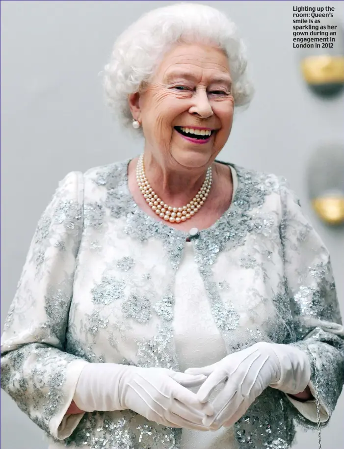  ?? ?? Lighting up the room: Queen’s smile is as sparkling as her gown during an engagement in London in 2012