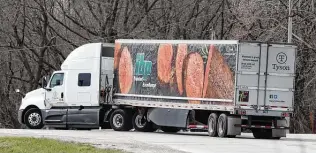  ?? Charlie Neibergall / Associated Press ?? A truck leaves the Tyson Foods pork plant in Perry, Iowa. It will take months to work through the backlog of millions of cattle and pigs that was created when dozens of plants were closed.