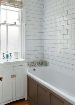  ??  ?? Below The couple opted for a calming and feminine scheme in the bedroom, creating a pretty backdrop with an archive wallpaper from Farrow & Ball.
Left For similar metro tiles, try Topps Tiles. For similar bath and basin taps, try the Bristan Trinity 2 range, Victorian Plumbing
