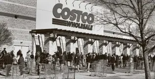  ?? Joe Raedle / Getty Images ?? People wait to shop at a Costco store in Austin. The retailer, which employs 180,000 people in the United States, will pay its employees $16 an hour. The company’s average wage is $24 an hour.