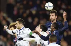  ??  ?? PARIS: Paris Saint-Germain’s Italian midfielder Thiago Motta (right) jumps to head the ball with Troyes’ French defender Matthieu Saunier (left) during the French L1 football match between Paris Saint-Germain (PSG) and Troyes yesterday. —AFP