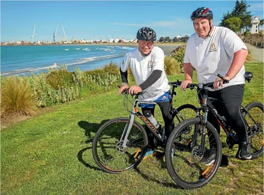  ??  ?? David Bond, left, and Mark Robertson stopped overnight in Timaru during their cycle journey to Christchur­ch to help Robertson lose weight and raise money for charity.