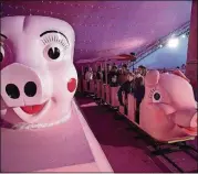  ?? STEVE SCHAEFER / SPECIAL TO THE AJC ?? A pink train full of people makes its way around the track beneath a 170-foot, 1950s-themed Macy’s Pink Pig tent in this file photo.