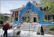  ?? STEVEN SENNE — THE ASSOCIATED PRESS ?? In this photo people walk near an entrance to The Amazing World of Dr. Seuss Museum, in Springfiel­d, Mass.