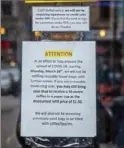  ?? Andrew Rush/Post-Gazette ?? Signs on the front of Nicholas Coffee Company in Market Square in Downtown Pittsburgh inform customers of the store’s closure amid efforts to help stop the spread of COVID-19.