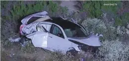  ?? ONSCENE TV ?? A girl was killed and two other children were injured when a woman who authoritie­s suspect was driving drunk crashed off Interstate 15 early Wednesday.