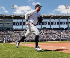  ?? David J. Phillip/Associated Press ?? Yankees outfielder Aaron Judge runs onto the field for the start of a spring training game against the Braves.