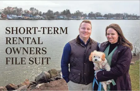  ?? ?? Short-term rental property owner David Comisford and his girlfriend Megan Bruno stand with their dog at Brooks Park, on Buckeye Lake, on Feb. 27 in Millerspor­t.