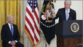  ?? (AP/Susan Walsh) ?? Former President Bill Clinton speaks as President Joe Biden listens during an event in the East Room of the White House on Thursday in Washington to mark the 30th Anniversar­y of the Family and Medical Leave Act. Clinton signed the FMLA into law 30 years ago.