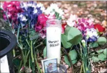  ?? BRICE TUCKER / THE FLINT JOURNAL VIA AP ?? A vigil candle reading “Spartan Strong” and flowers sit outside Berkey Hall following a mass shooting on campus the night before, at Michigan State University, in East Lansing, Mich. on Tuesday.
