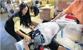  ?? Mel Melcon Los Angeles Times ?? IN LOS ANGELES, Tere Caicedo packs donated items destined for her native Venezuela. She and a group of volunteers have sent about 8,000 pounds of aid.