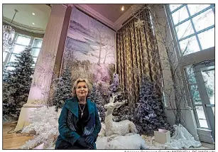  ?? Arkansas Democrat-Gazette/MITCHELL PE MASILUN ?? Susan Hutchinson stands in front of one of two panels depicting Spavinaw Creek that are part of the Christmas display in the Janet M. Huckabee Grand Hall at the Governor’s Mansion.