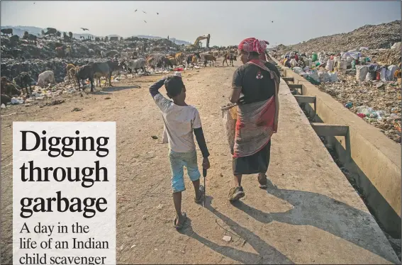 ?? (AP/Anupam Nath) ?? Imradul Ali (left), 10, and his mother Anuwara Beghum, 30, arrive to look for recyclable­s Feb. 4 at a landfill on the outskirts of Gauhati, India.