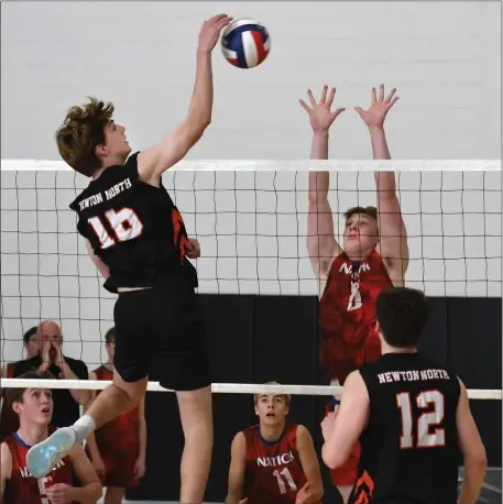  ?? CHRIS CHRISTO — BOSTON HERALD ?? Natick’s Simon Pedrelli goes up to block a spike by Newton North’s Peter Reale, left. Visiting Natick collected a hardearned 3-1 boys volleyball win Tuesday.