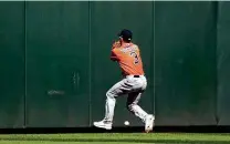  ?? Abbie Parr / Getty Images ?? The Astros’ Myles Straw can’t make a catch on what winds up being a two-run triple by the Mariners’ Mitch Haniger in the fifth inning. The hit gave Seattle a 3-2 lead at T-mobile Park.