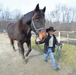  ?? ROBERT DEUTSCH/USA TODAY ?? Lacey Trezza, 8, helps out at JL Performanc­e Horses in Poughquag, N.Y., in exchange for a summer spot that costs $3,780.