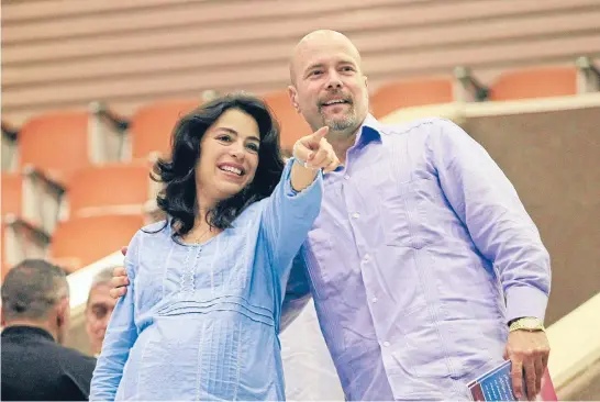  ?? Photos: REUTERS ?? Together again: Gerardo Hernandez, one of so-called ‘‘Cuban Five’’, hugs his pregnant wife Adriana Perez during the National Assembly in Havana.