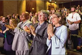  ?? TOM MCCARTHY JR. / FOR AMERICAN-STATESMAN ?? Clay Johnston (second from right), dean of the UT College of Medicine, and Sharon Wood (right) dean of the College of Engineerin­g, applaud Tuesday as UT President Gregory L. Fenves takes the stage.