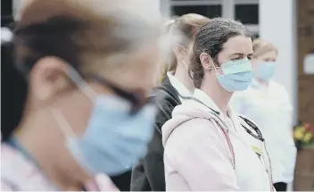  ??  ?? Pictures show staff at the two-minute silence at Scarboroug­h Hospital on Tuesday. Pictures by Richard Ponter