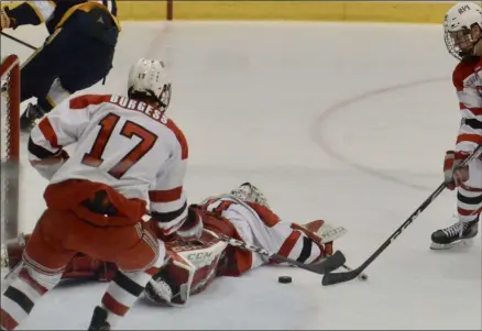  ?? PHOTO BY JILLIAN HOWARD ?? Owen Savory makes a breakaway save and scrambles Saturday night against Canisius before Will Reilly is able to come in and help clear the puck.