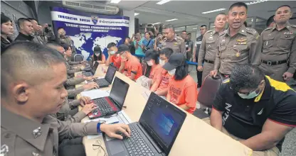  ?? SOMCHAI POOMLARD ?? Seven suspects, all wearing face masks, appear at a press conference held yesterday to announce their arrests. Five were detained on Friday and the other two on Saturday when they attempted to sit an American College Testing (ACT) exam for other people using fake passports.