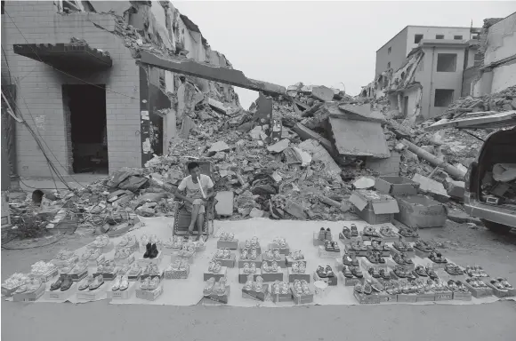  ??  ?? A VENDOR waits for customers at a market in an urban village under demolition in Zhengzhou, Henan province, China, on May 20.