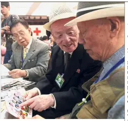  ??  ?? Bitterswee­t: South Korean Kim Byung-oh (left), 88, crying with his North Korean sister Kim Sun-ok, 81, as two elderly gentlemen (above) reminisce over pictures at the last meeting of the reunion event at Mount Kumgang. — AFP