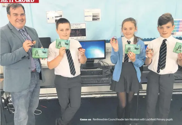  ??  ?? Game on Renfrewshi­re Council leader Iain Nicolson with Lochfield Primary pupils