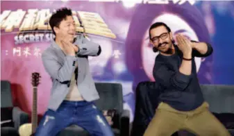  ??  ?? January 24, 2018: Indian movie star Aamir Khan teaches Chinese actor Huang Bo Indian dance moves at a seminar promoting the Indian film Secret Superstar in Beijing. VCG