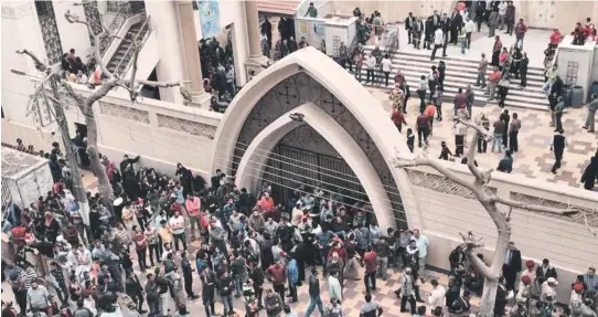  ?? AP PHOTOS ?? CARNAGE: Relatives and onlookers gather outside a church after a bomb attack in the Nile Delta town of Tanta, Egypt, yesterday. People react in anger, below, following an explosion at St. Mark’s Cathedral in the coastal city of Alexandria.