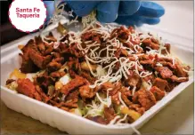  ?? RAY CHAVEZ — STAFF PHOTOGRAPH­ER ?? Santa Fe Taqueria
Layers of cheese, sour cream, guacamole and pico de gallo top the carne asada fries at San Jose's Santa Fe Taqueria.