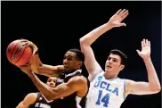  ?? AP PHOTO BY JOHN MINCHILLO ?? St. Bonaventur­e's Idris Taqqee, left, rebounds against UCLA'S Gyorgy Goloman (14) during the first half of a First Four game of the NCAA men's college basketball tournament, Tuesday in Dayton, Ohio.