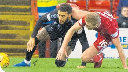  ??  ?? Goldson tangles with Aberdeen hit-man Sam Cosgrove at Pittodrie last midweek