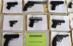  ?? M. SPENCER GREEN/THE ASSOCIATED PRESS ?? Chicago police display some of the thousands of illegal firearms they have confiscate­d so far this year in their battle against gun violence in Chicago.