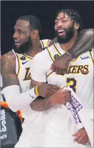  ?? MARK J. TERRILL — THE ASSOCIATED PRESS ?? RIGHT: Los Angeles Lakers’ LeBron James and Anthony Davis celebrate after the Lakers defeated the Miami Heat in Game 6of the NBA Finals on Sunday in Lake Buena Vista, Fla.