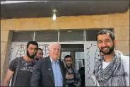  ?? AP/Syrian Emergency Task Force/MOUAZ MOUSTAFA ?? Mouaz Moustafa (right) joins Sen. John McCain on a visit with Syrian rebels after they slipped into the war-torn Aleppo province for a surprise visit in May 2013. Pro-democracy Syrians, he said, are “grieving and mourning the loss of John McCain as if it were the loss of a family member.”