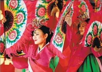  ?? Photograph­s by Gary Coronado Los Angeles Times ?? THE KOREAN DANCE ACADEMY performs Sunday at the Alhambra Lunar New Year Festival. The event showed the paradoxes of a city in mourning: the need to remember and the need to move on.