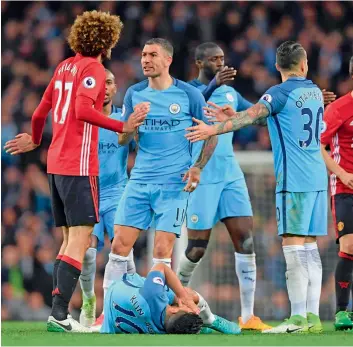  ?? — AFP ?? Manchester City’s Aleksandar Kolarov (centre) reacts after his team mate Sergio Aguero went down in an altercatio­n with Manchester United’s Marouane Fellaini (left) who was sent off during the English Premier League match at Etihad Stadium in...