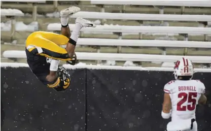  ?? AP ?? Iowa receiver Ihmir Smith- Marsette flips in the end zone after catching the second of his two touchdown passes Saturday.