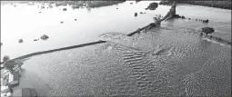  ?? YELL COUNTY SHERIFF’S DEPARTMENT ?? Water rushes through a breached levee along the Arkansas River on Friday in Dardanelle, Arkansas. Floodwater­s coming through the 40-foot hole threaten hundreds of homes.