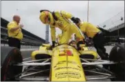  ?? MICHAEL CONROY — THE ASSOCIATED PRESS ?? Helio Castroneve­s climbs into his car during a practice session on May 21 at Indianapol­is Motor Speedway.