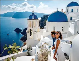  ??  ?? SUN-DRENCHED: The stunning white-and-blue buildings of Santorini