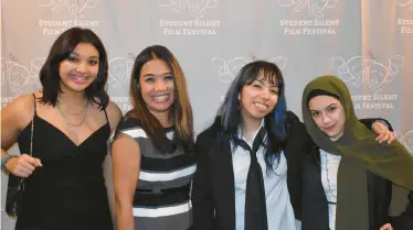  ?? JOHN JASMIN ?? Bella Pelini, from left, Jodi Pelini, Daniella Ramirez Prado and Saidah Diab pause on the red carpet Wednesday during the Student Silent Film Festival at the Tivoli Theatre in Downers Grove.