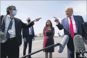  ?? ALEX BRANDON — THE ASSOCIATED PRESS ?? President Donald Trump talks to reporters at Phoenix Sky Harbor Internatio­nal Airport Monday in Phoenix. Second from right is Sen. Martha Mcsally, R-ariz.