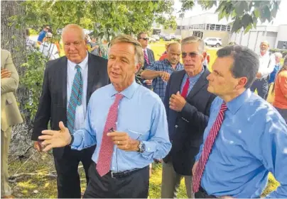  ?? FILE PHOTO BY DAVE FLESSNER ?? Tennessee Gov. Bill Haslam, center, talks in July 2017 about the $27.1 million investment a new textile company planned in Pikeville to create 1,000 jobs. With Haslam, from left, are Pikeville Mayor Philip “Winky” Cagle, Bledsoe County Mayor Gregg...